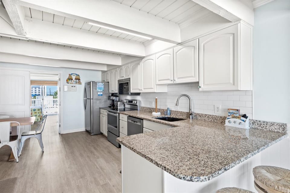 Just off the Living Area, the spacious Kitchen is well-stocked & stunning.