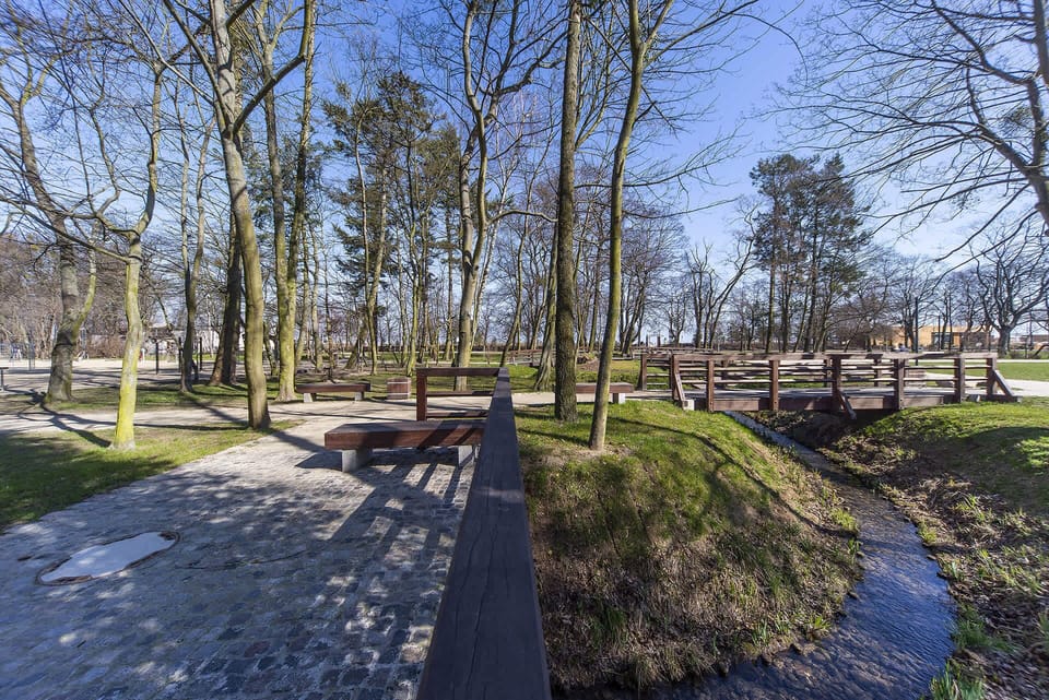 A closer look at the same park, showing a well-maintained walking path surrounded by greenery.