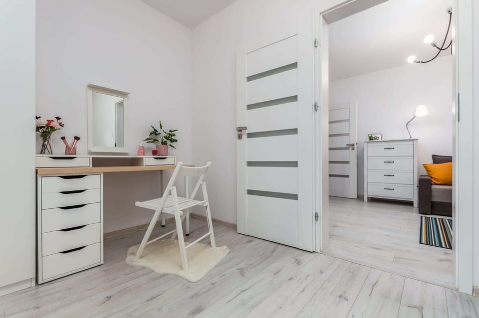 A quiet, well-arranged area with a desk that is ideal for remote work or studying at a computer.