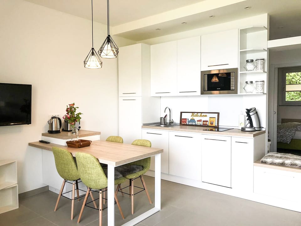 New kitchen with dishwasher, toaster, coffee machine, fridge, microwave, etc.