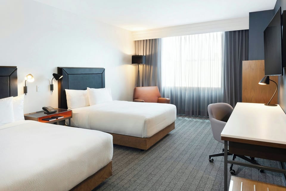 Room, 2 Double Beds | Hypo-allergenic bedding available, pillowtop beds, in-room safe, desk