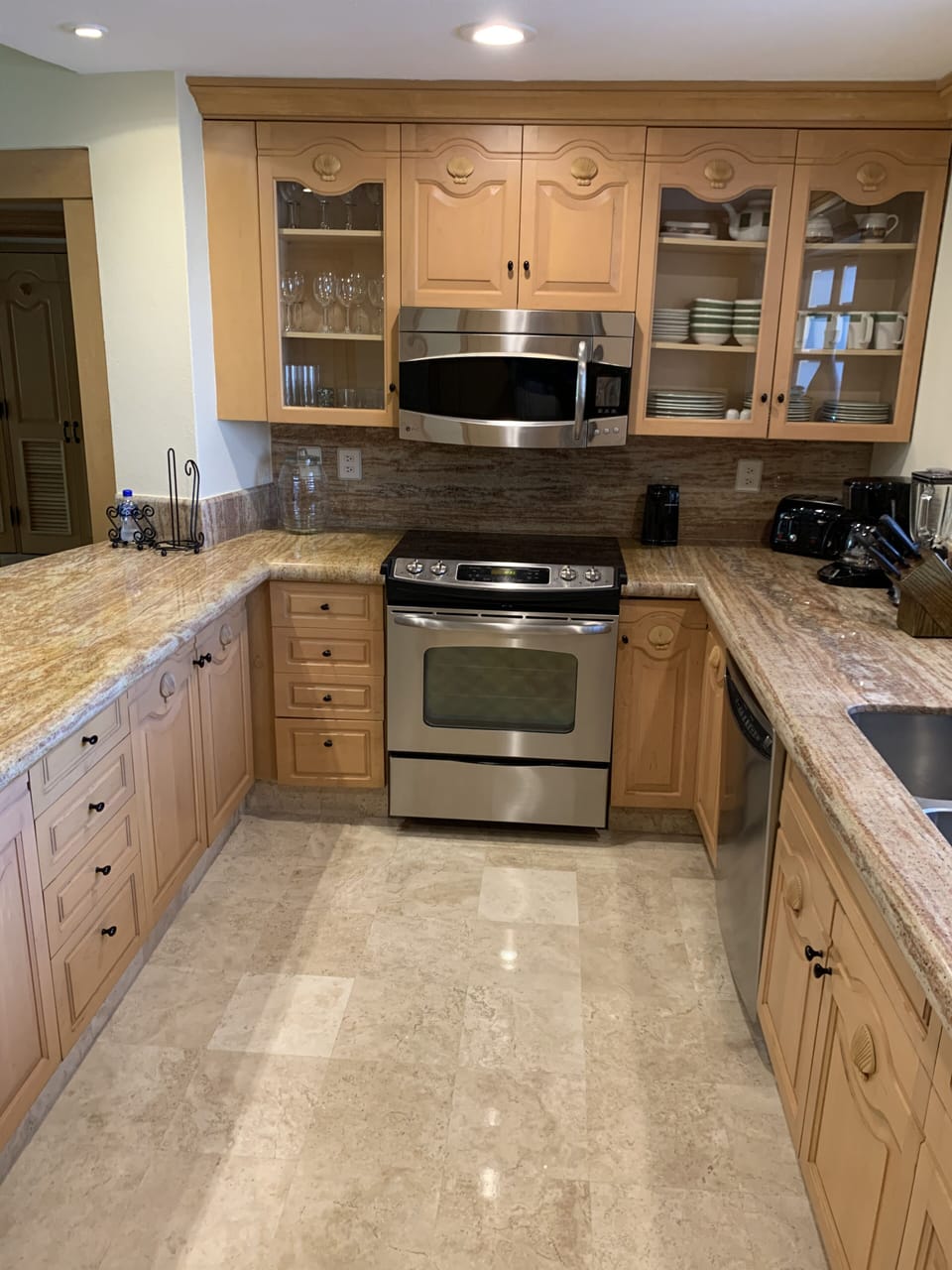 Kitchen oven, microwave, and fully stocked cabinets and drawers