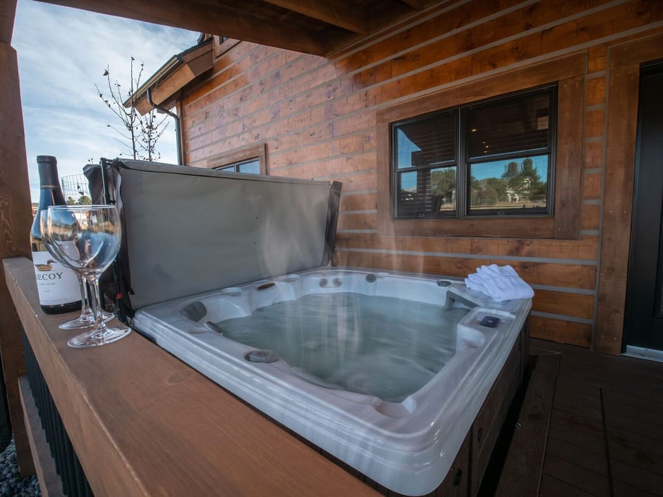 Outdoor patio with fireplace and hot tub