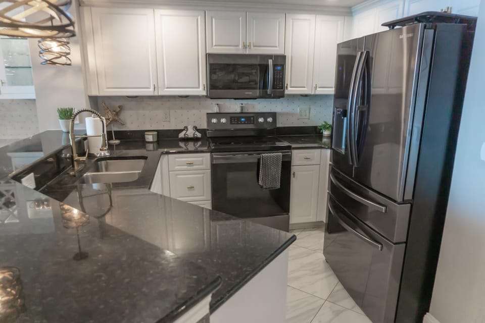 Modern kitchen with sleek appliances and granite countertops