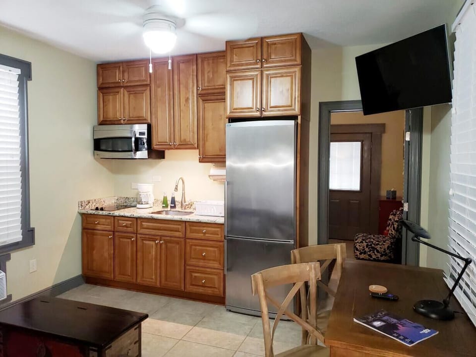 Kitchenette in den area with bedroom entrance to right.