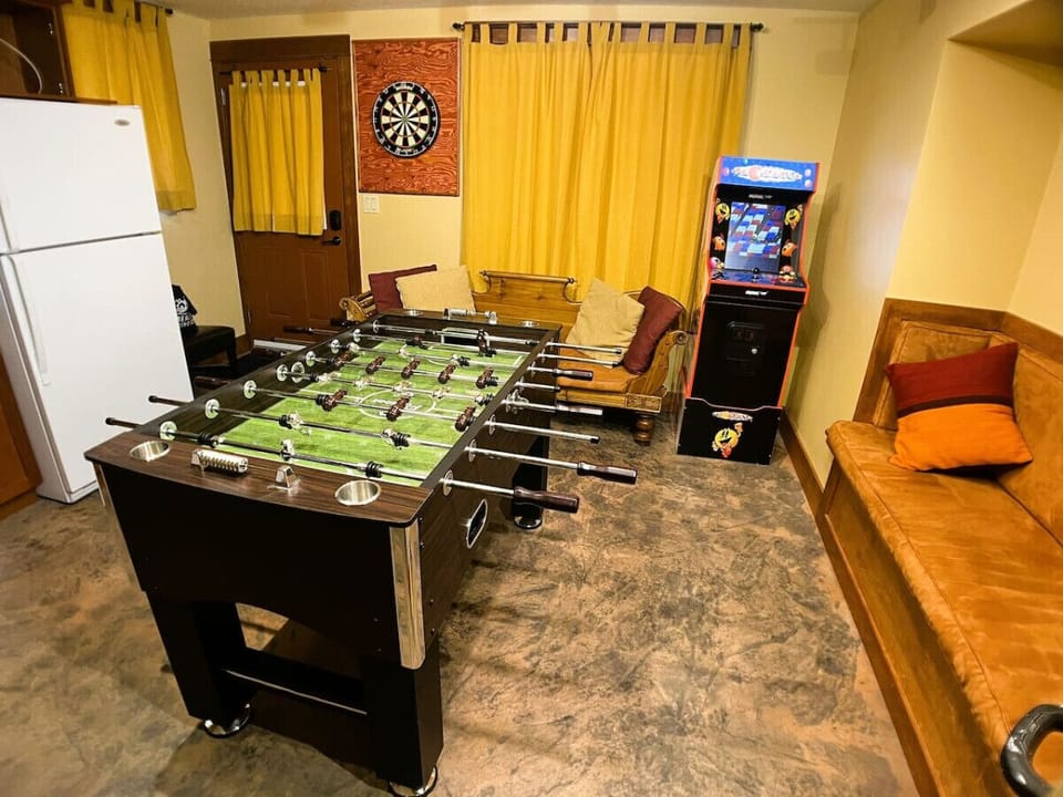 Games Room.  Retro 80`s Arcade Game with Pac Man, Arcada and variety of others.  Foosball Table.  Dart Board that is set to Professional Measurements/Standards.  Complete with Beer Fridge! Exit to Hot tub area is door on the left.