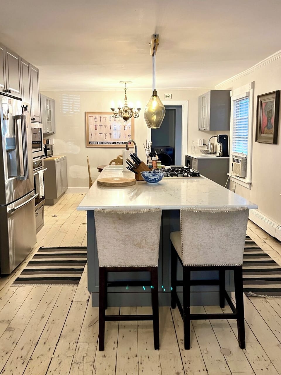 Views of the living room overlooking the island-style kitchen. 