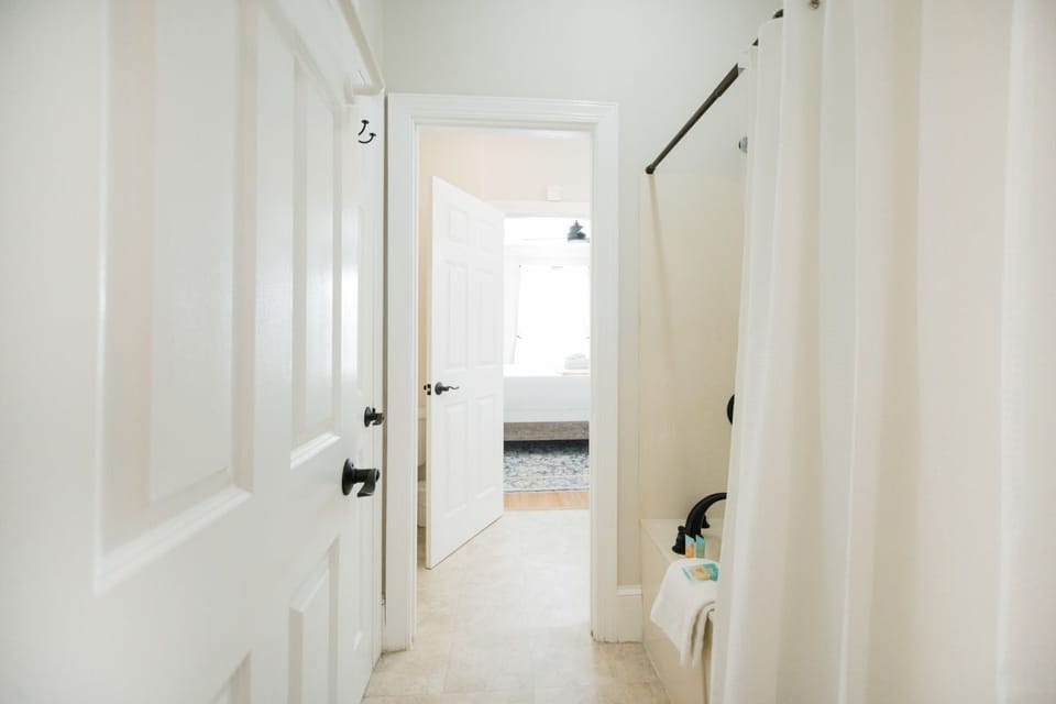 Shared between the two rooms, you will find the large soaking tub and shower combination.