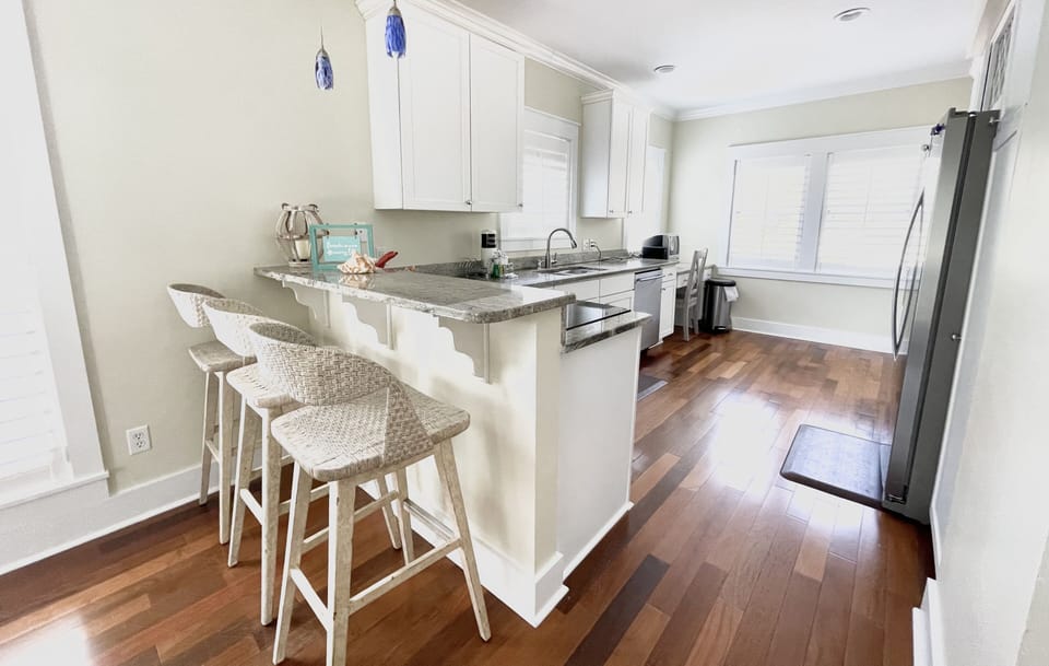 Wide galley kitchen with high end appliances, granite counter tops and a fully equipped kitchen.