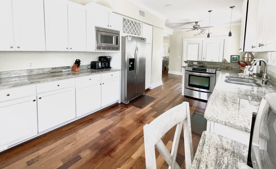 Wide galley kitchen with high end appliances, granite counter tops and a fully equipped kitchen.