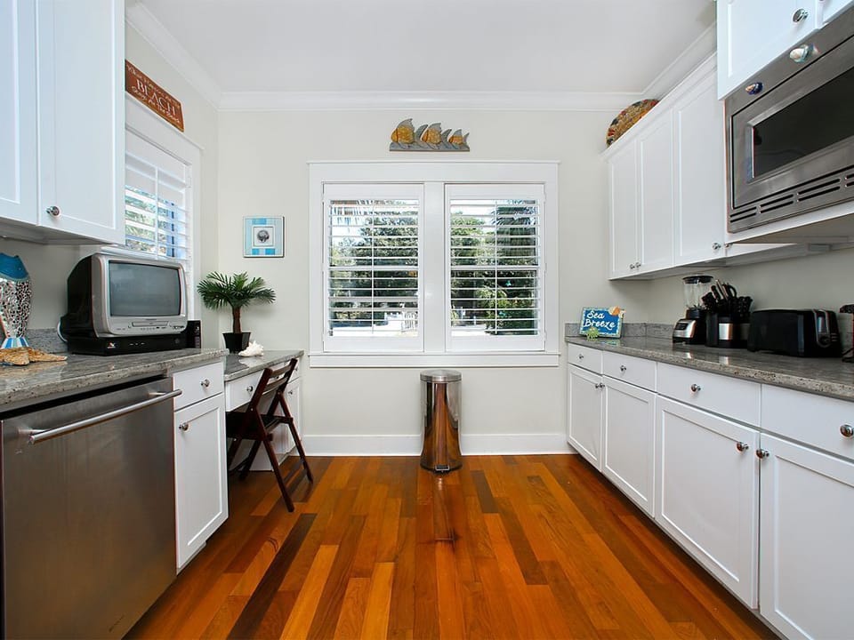 Wide galley kitchen with high end appliances, granite counter tops and a fully equipped kitchen.