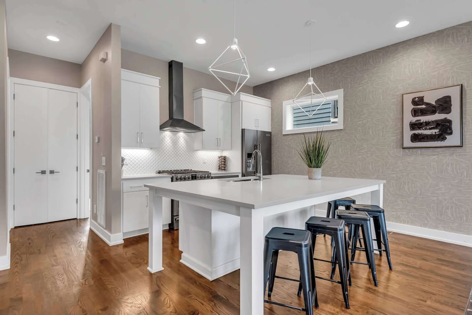 The over-sized kitchen island features comfortable seating and an open layout that perfect for enjoying meals together
