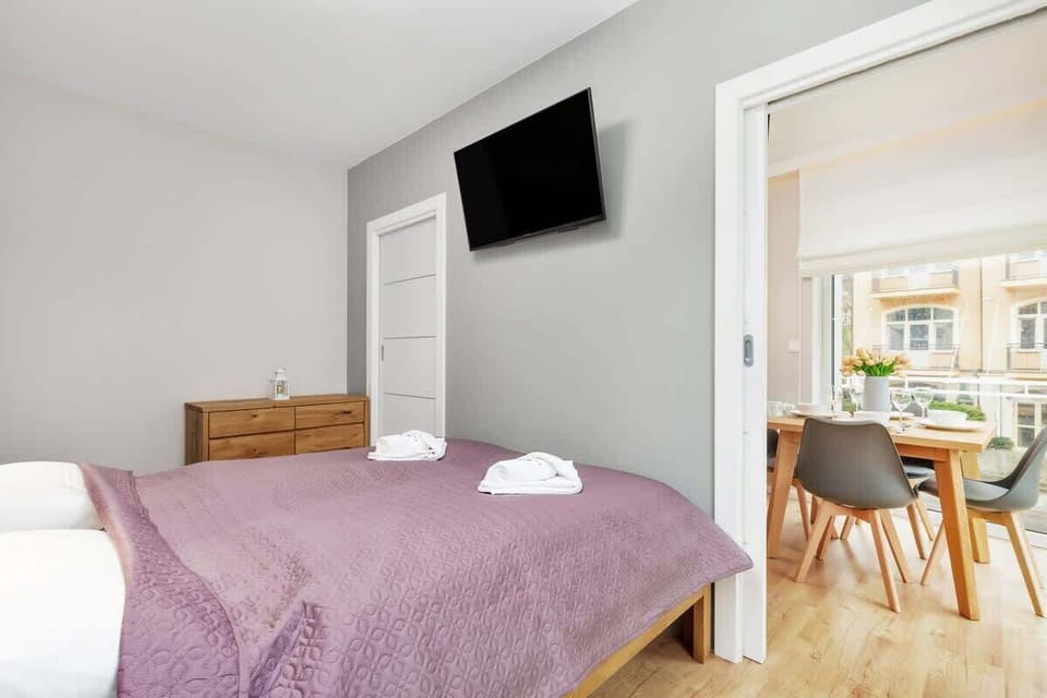 The main entrance to the apartment includes a dark wooden door, complemented by neutral-toned walls and flooring.