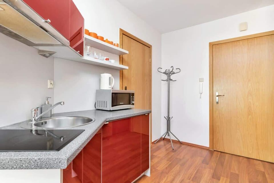 The kitchenette's compact design includes a fridge, microwave, and toaster for your convenience.