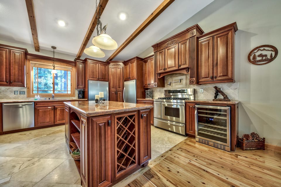 Step into your gourmet kitchen with rich wood cabinetry, granite counters, and professional stainless appliances - perfect for creating memorable meals.