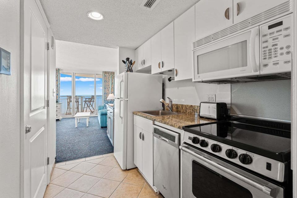 Kitchen counter and sink with an ocean view at Avista Ocean Resort 1514, a 1-bedroom Ocean Drive vacation rental