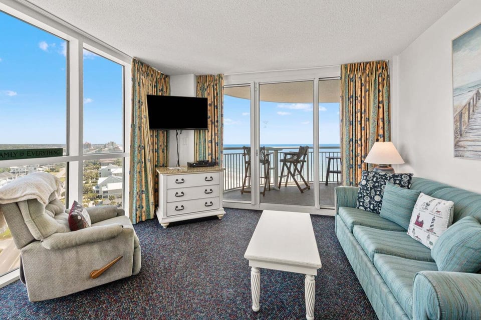 Sectional seating and sliding doors to the oceanfront balcony at Avista Ocean Resort 1514, a 1-bedroom Ocean Drive condo