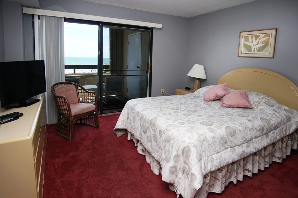 Bedroom with balcony doors and ocean views at Sea Pointe 204, Cherry Grove, North Myrtle Beach