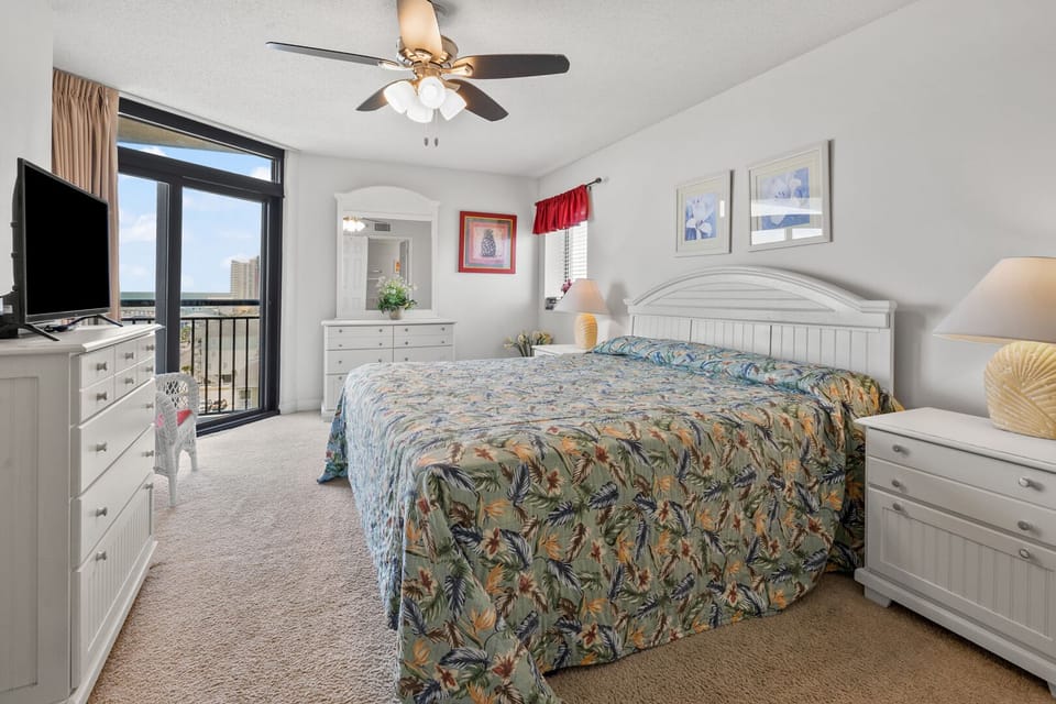 Bedroom with sliding doors to the ocean-view balcony at Beachwalk Villas 401, a 2-bedroom condo rental