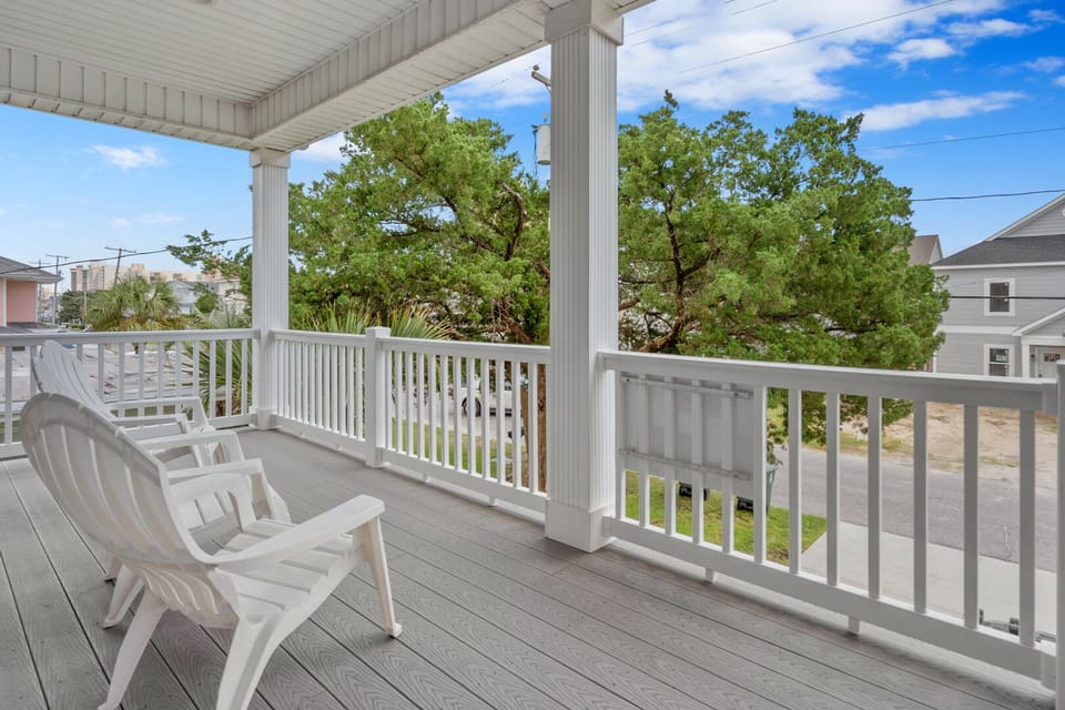 Adirondack chairs on the covered porch at Cole's Gold, a 5-bedroom Crescent Beach vacation rental