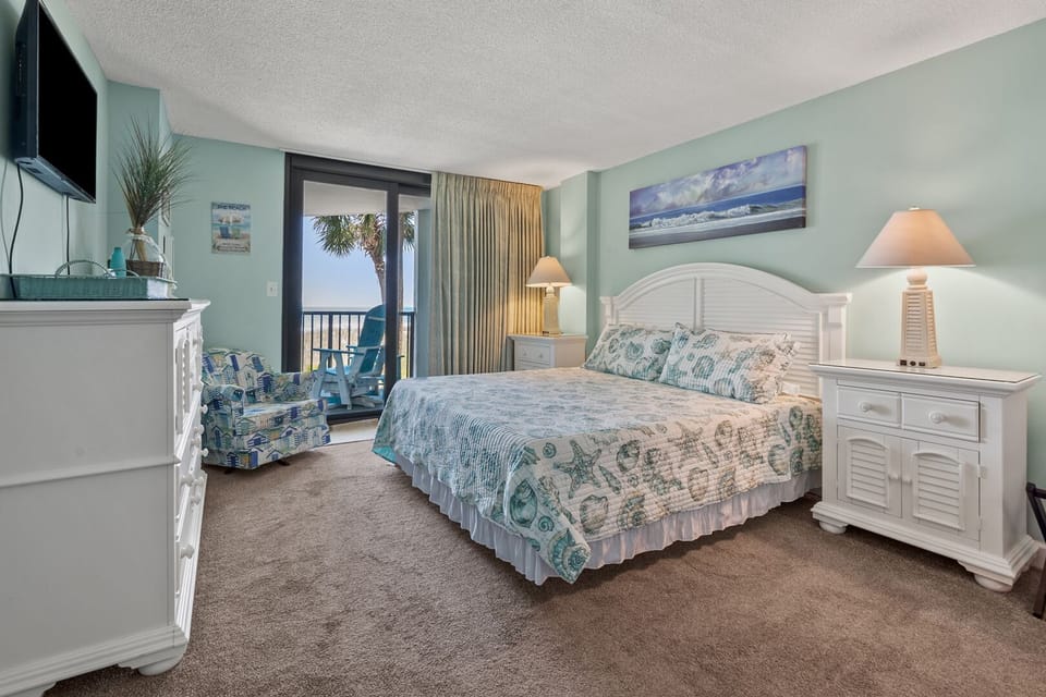 Bedroom with balcony doors and an ocean outlook at Crescent Sands of Crescent Beach I1, a 3-bedroom condo