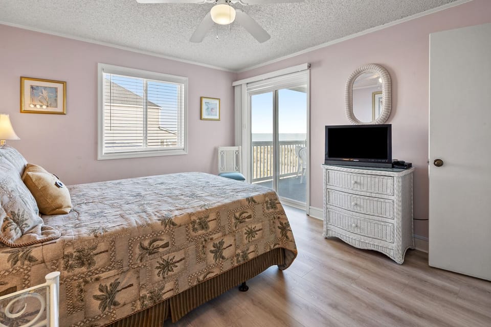 Bedroom with balcony doors and ocean views at Beachmaster 208 in Cherry Grove, North Myrtle Beach