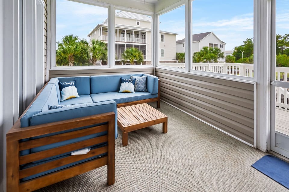 Cushioned sectional on the covered porch at Beach Landing, a Tilghman Beach vacation rental