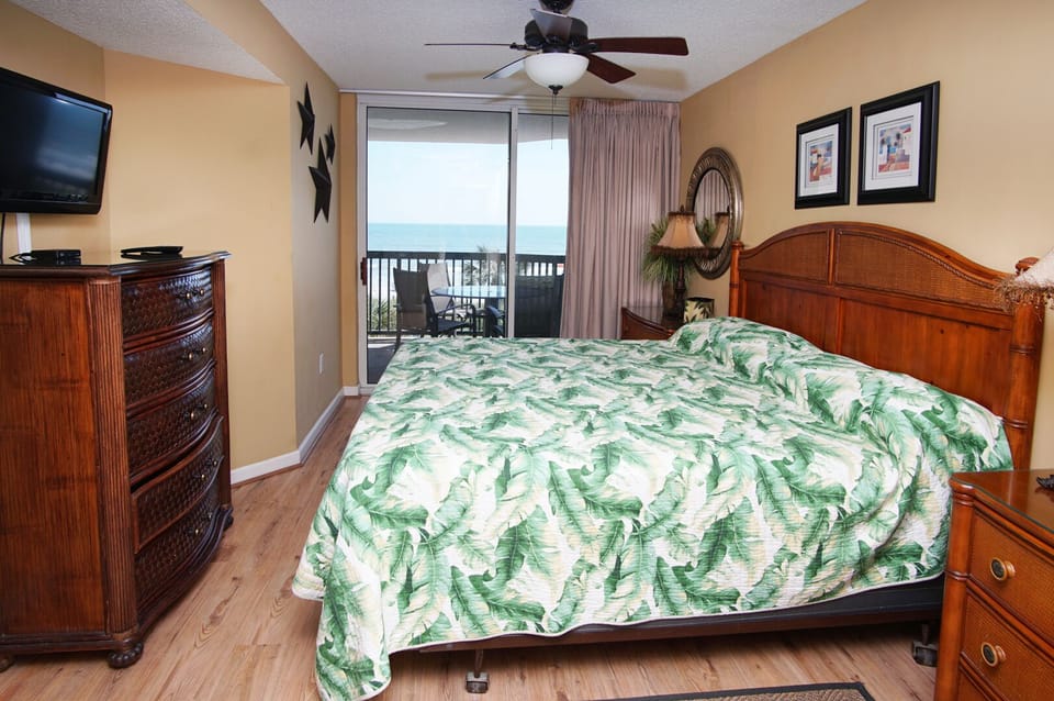 Bedroom with balcony doors and an ocean view at Ashworth 209, a 4-bedroom Ocean Drive vacation rental