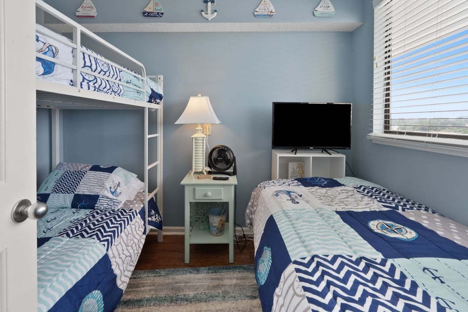 Bunk beds and a wall TV make a nautical bedroom for the kids at Windemere 703, Ocean Drive, North Myrtle Beach
