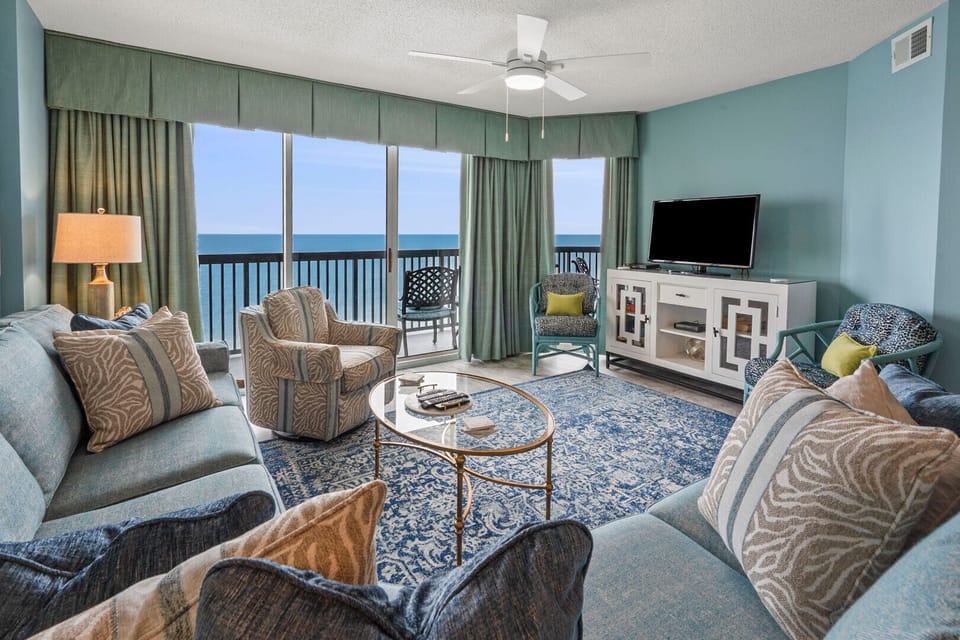 Living room with a sectional, TV and ocean views at Ashworth 1704, an Ocean Drive vacation rental