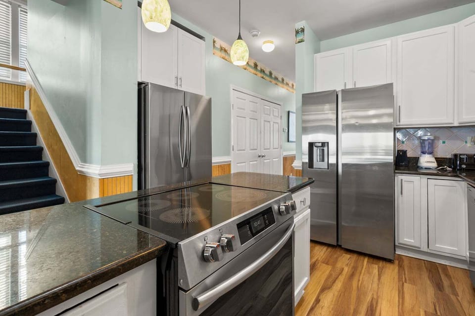 Cooktop and full-size refrigerator in the white kitchen at Diamond Dunes B, Crescent Beach