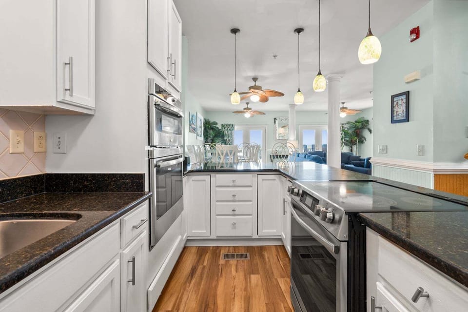 Wide kitchen with a range, wall ovens and dark counters at Diamond Dunes B, an 8-bedroom North Myrtle Beach rental