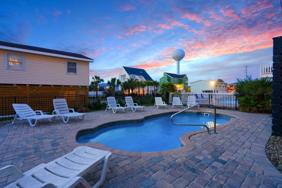 Curved pool and lounge chairs at A Perfect Escape, a 6-bedroom Cherry Grove rental in North Myrtle Beach