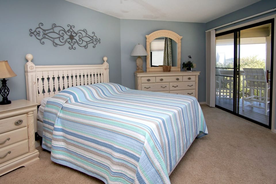 Bedroom with sliding doors opening onto the balcony at Tilghman Lakes N4, a 2-bedroom home in Tilghman Beach