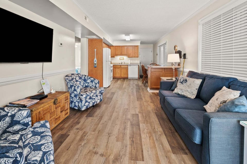 Patterned armchairs and the kitchen beyond in the living area at Summer Place C3, Cherry Grove