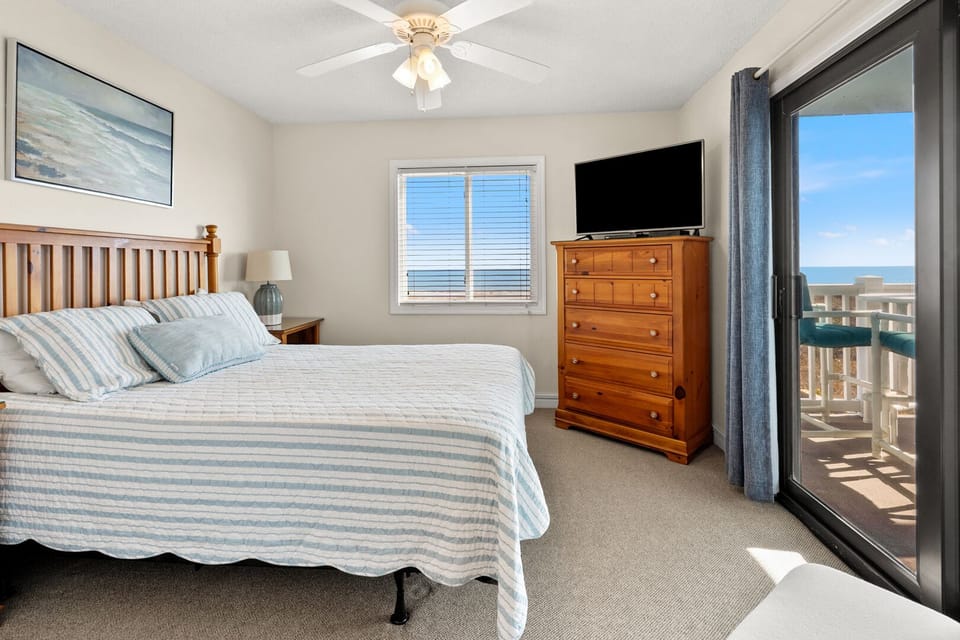 Bedroom with balcony doors and an ocean view at Surf Villas I B2, a 3-bedroom Ocean Drive condo rental