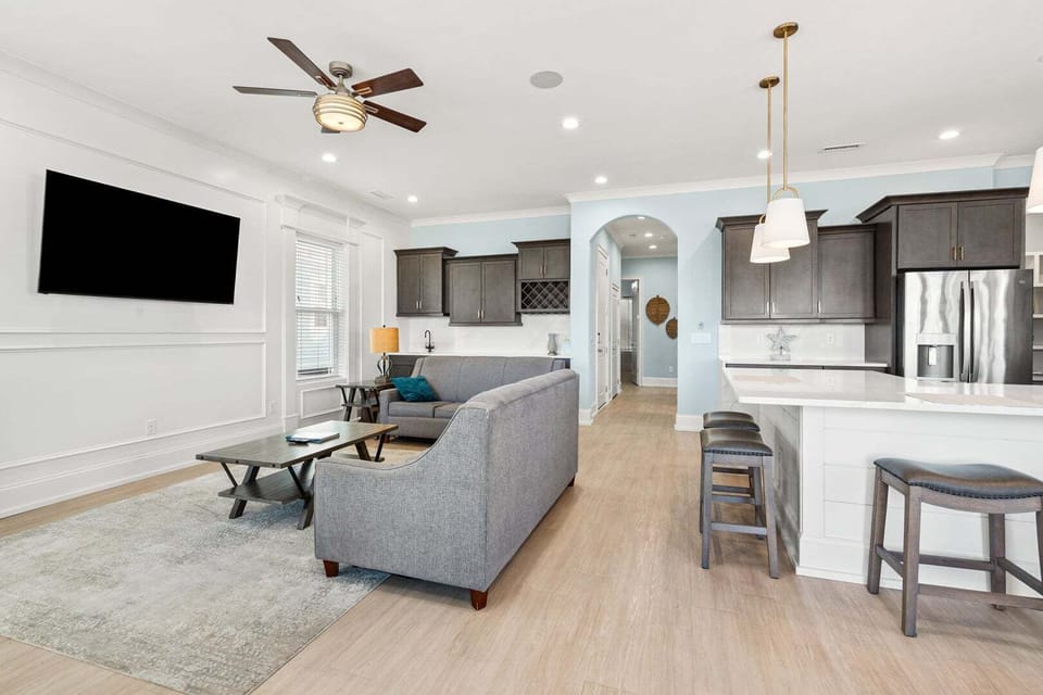 Gathering space with soft blue walls and a kitchen island at A New Beginning in Cherry Grove, North Myrtle Beach