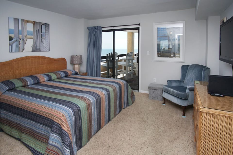Bedroom opening to the balcony with an ocean view at Sea Pointe 609, a 2-bedroom Cherry Grove condo