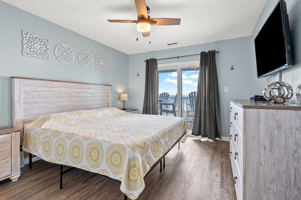 Bedroom with balcony doors and ocean view at Surf Villas II D3, a 3-bedroom Ocean Drive vacation rental