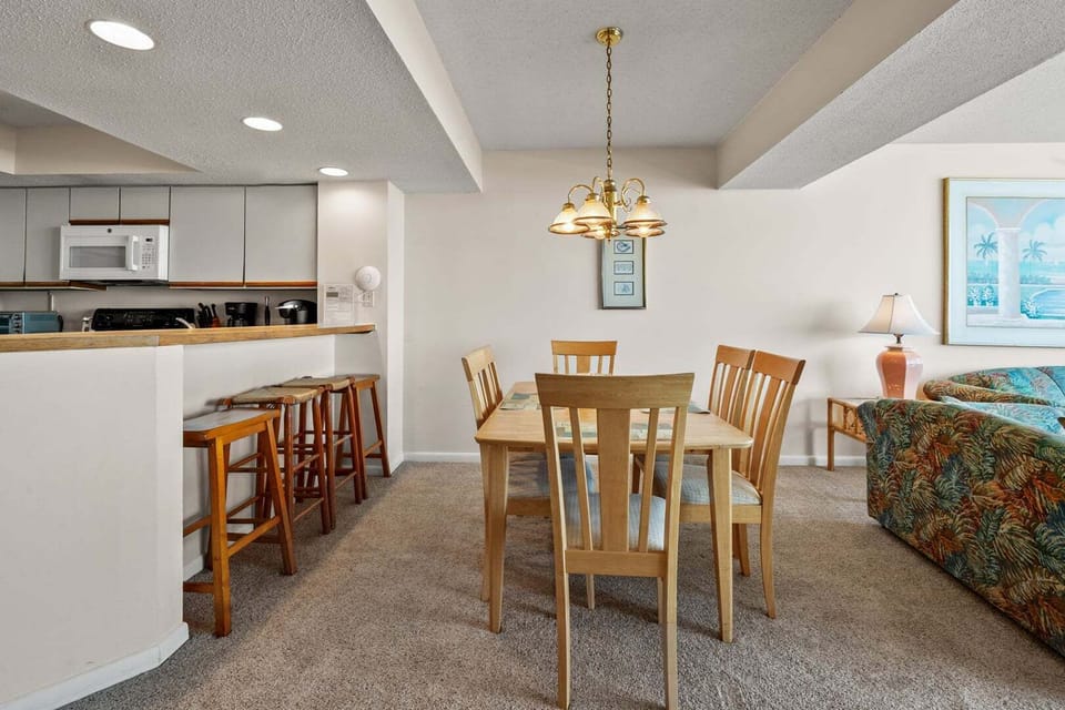 Dining area open to the kitchen bar and living room at Shoreham Towers II 2D in Crescent Beach, North Myrtle Beach
