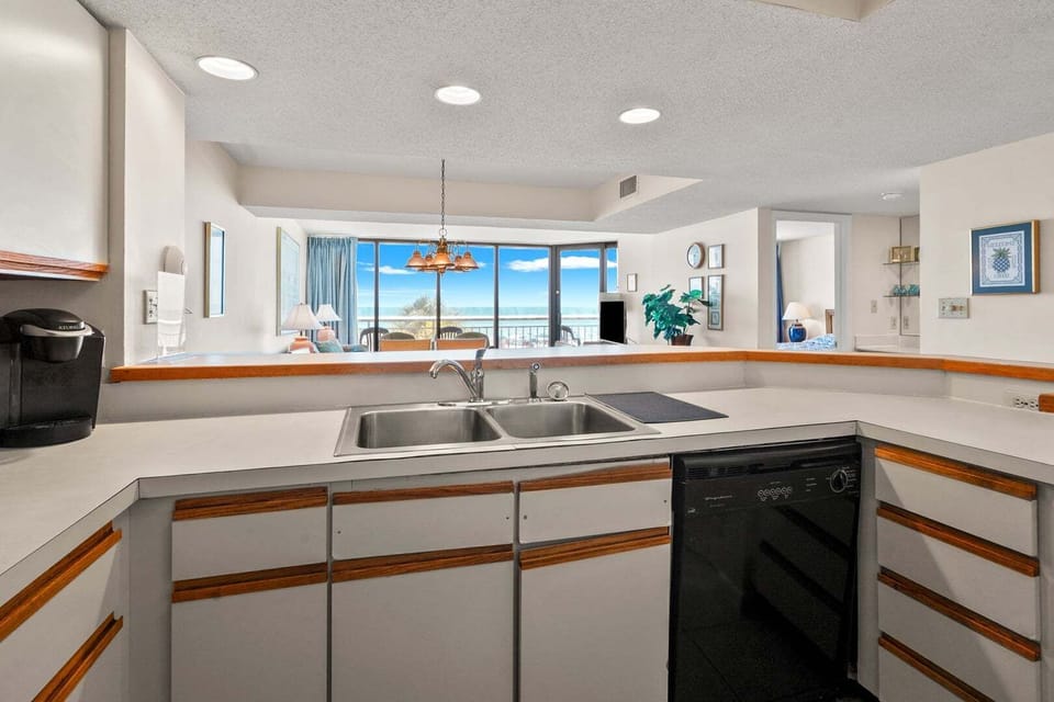 Kitchen window framing the ocean above the sink at Shoreham Towers II 2D, a Crescent Beach condo rental