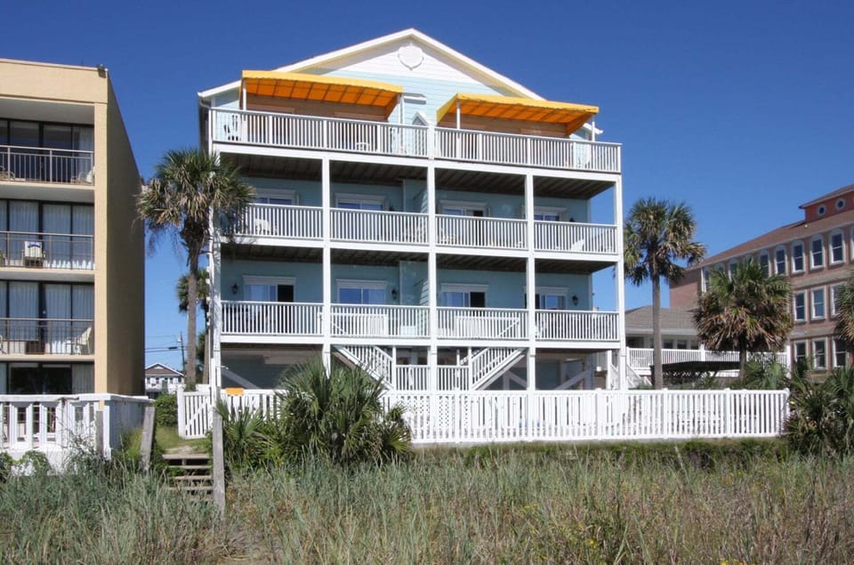 Balconies and yellow awnings at Diamond Dunes A, an 8-bedroom oceanfront vacation rental in Crescent Beach