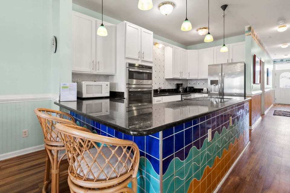 Kitchen with a blue and green island and bar stools at Diamond Dunes A, Crescent Beach, North Myrtle Beach