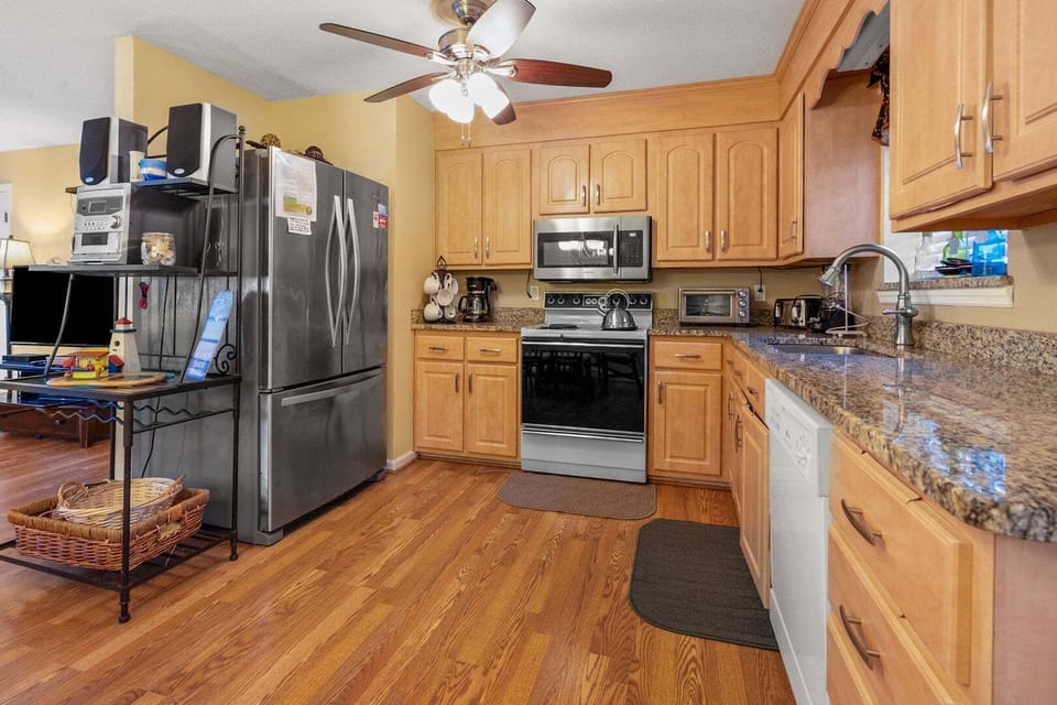 Kitchen with light cabinetry, full appliances and a ceiling fan at Blue Atlantic in the Ocean Drive section