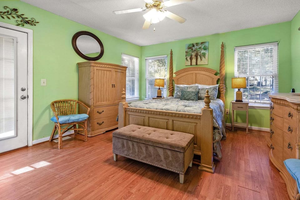 Bedroom with a four-poster bed and green walls at Blue Atlantic, an Ocean Drive vacation rental