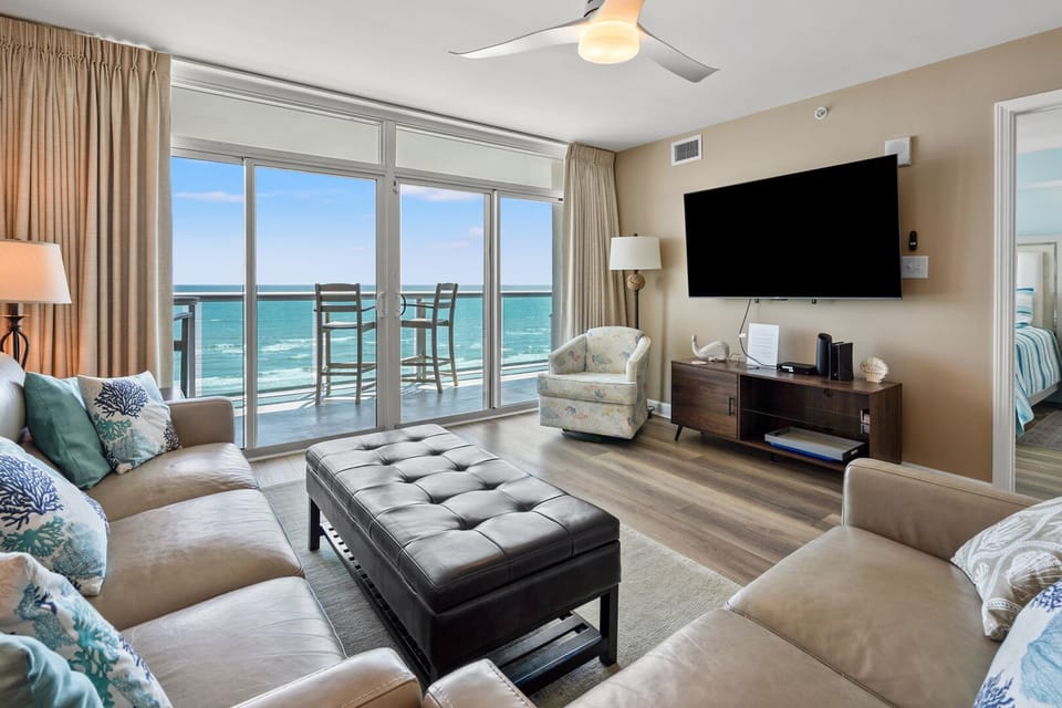 Sliding doors open from the living area to the oceanfront balcony at Laguna Keyes 603, a 3-bedroom Cherry Grove condo