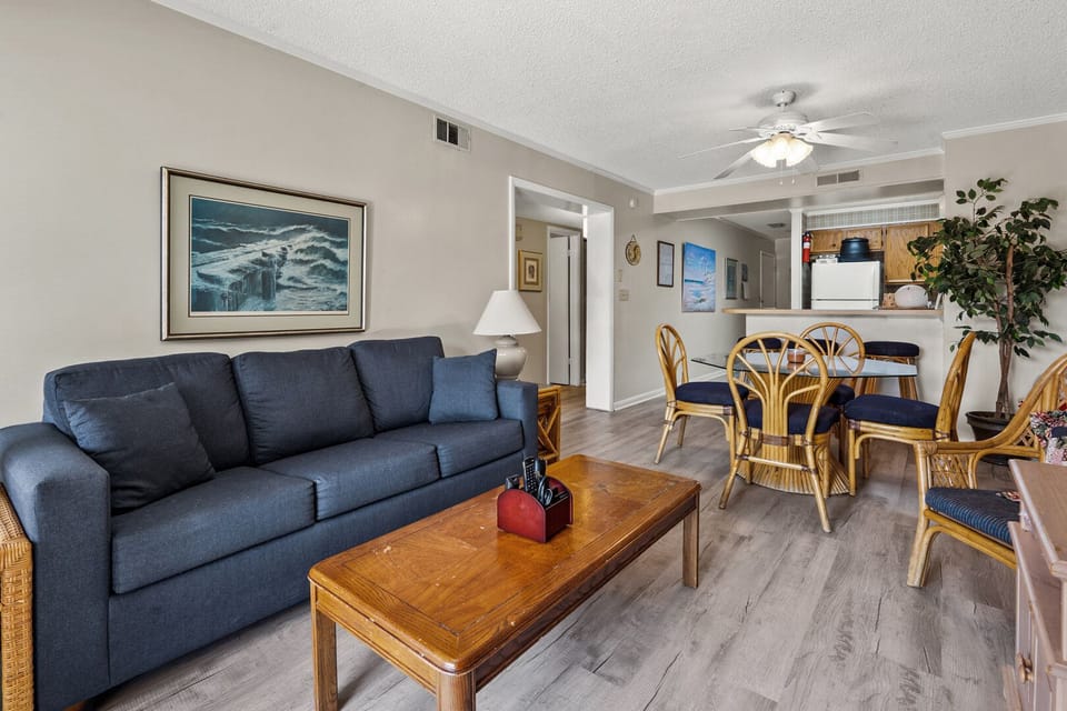 Open living and dining space with ceiling fan at Tilghman Beach & Racquet Club 140, Ocean Drive