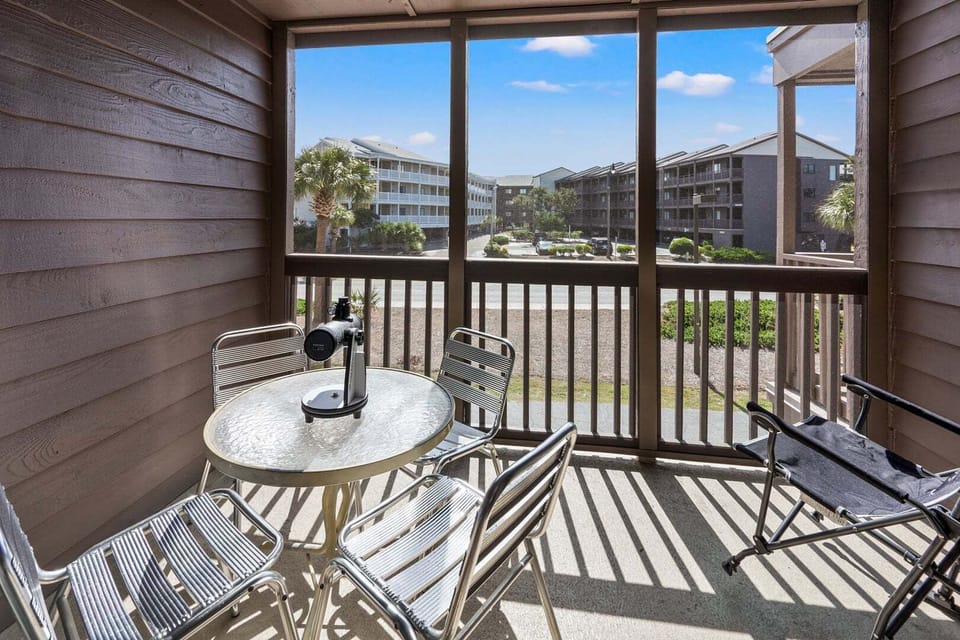 Balcony table and chairs at Tilghman Beach & Racquet Club 140, a 3-bedroom Ocean Drive vacation rental
