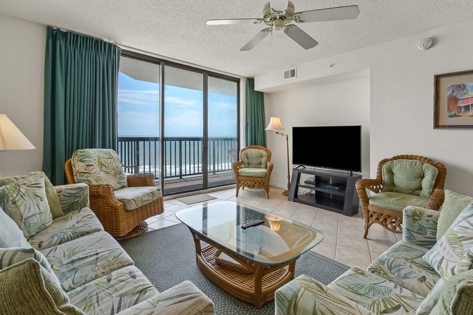 Sectional seating and tropical prints facing the ocean at Ocean Bay Club 904, a 4-bedroom Ocean Drive condo