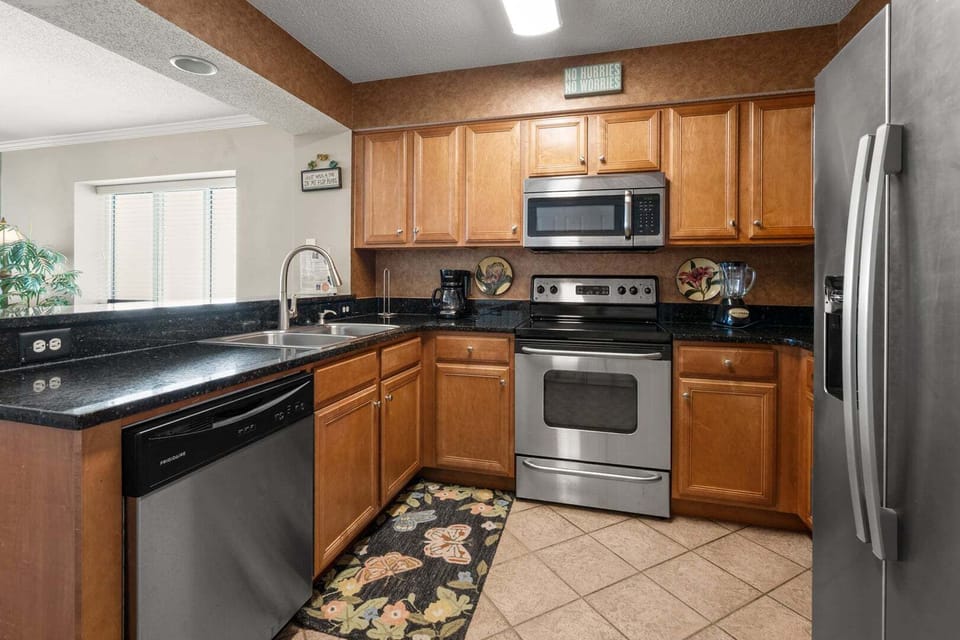 Everyday kitchen with oven, microwave and dark counters at South Shore Villas 1207 in Crescent Beach